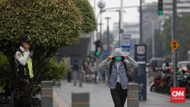 Warga melintas di bawah terik matahari saat suhu di Jabodetabek mencapai puncaknya hingga 36 derajat Celcius. (Foto: RSS)